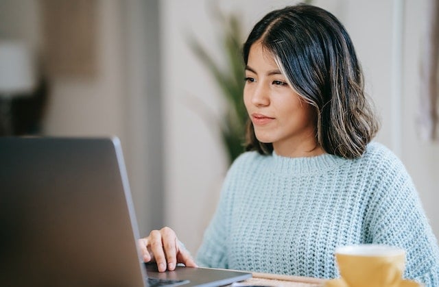 woman using laptop to research cloud migration